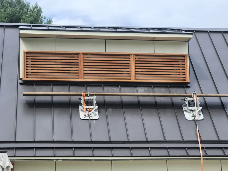 Cedar louver panel on a metal roof